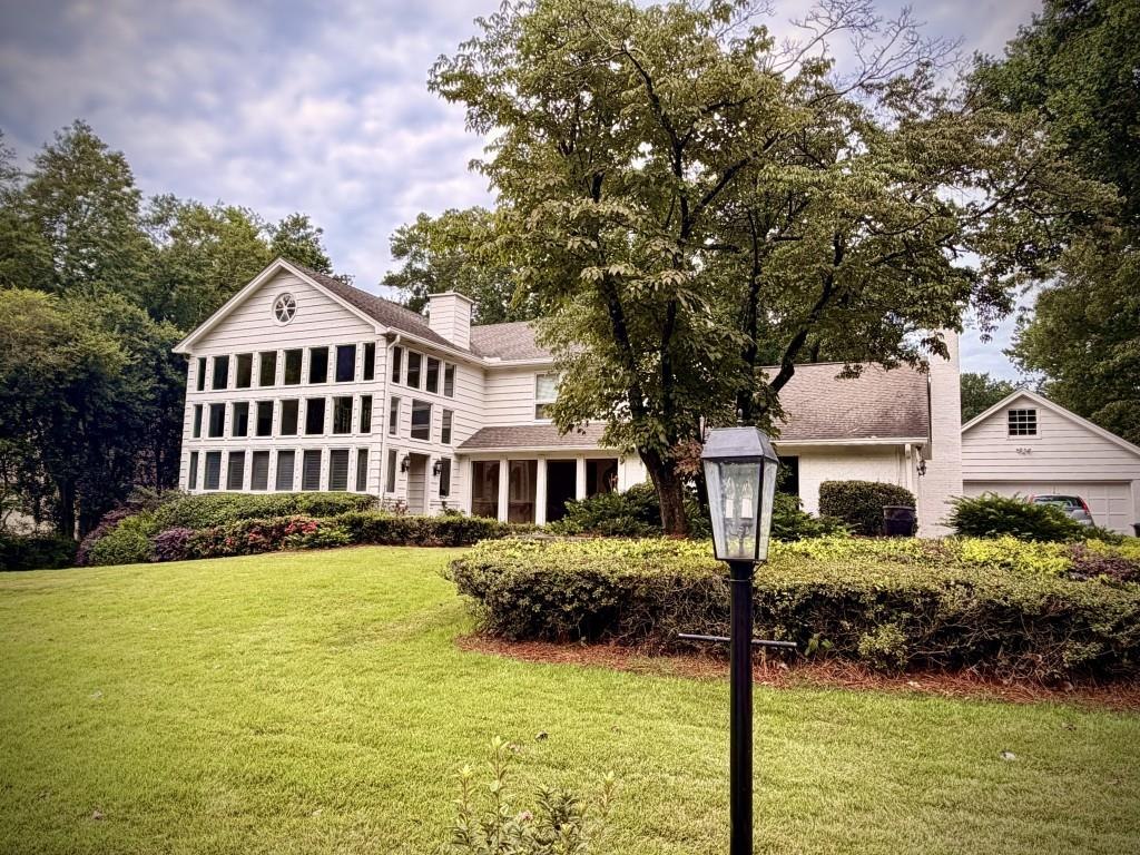 Estate-style home with mature landscaping